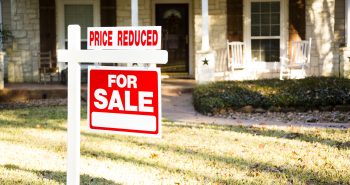 For sale sign with price reduced